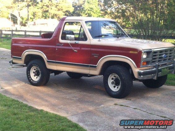Red and tan Ford Bronco parked on a driveway