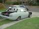 1970 Ford Falcon - This sedan is in primer, with its trunk open, revealing a battery and some wiring.