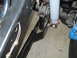 1992 Ford Bronco - Detail of a vehicle's suspension system, showing a shock absorber and mounting bracket.