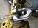 1992 Ford Bronco - A close-up view of a tubing bender tool attached to yellow machinery, with a Supermotors.net watermark visible.