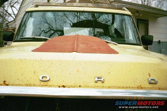 Yellow 1979 Ford Bronco front view with red hood scoop and chrome Ford lettering