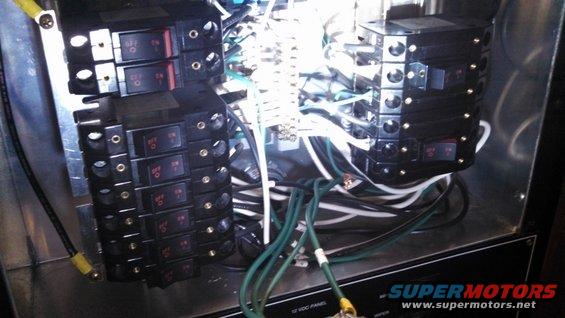 Close-up of a boat's electrical breaker panel with multiple switches and wiring