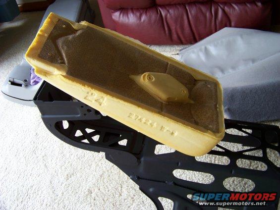 Car seat foam and black metal frame with visible text '27424 17-8'