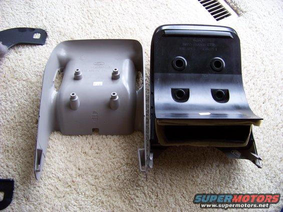 Two plastic car interior trim pieces, one gray and one black, on a carpeted surface