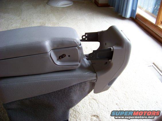 Gray center console armrest with visible mounting brackets