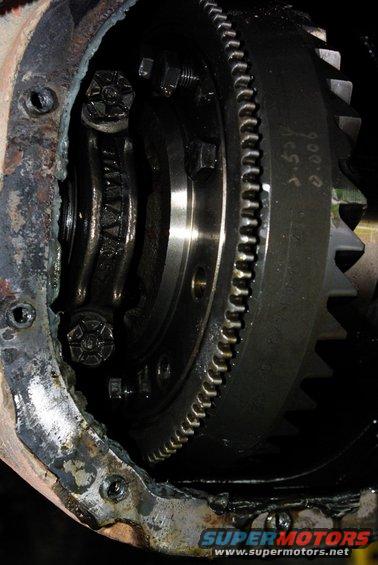 Differential gear assembly with visible teeth and bolts. Text reads '3.54 0.006'