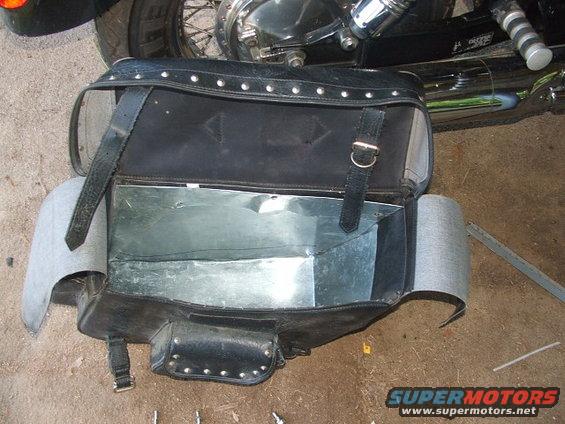 Black leather motorcycle saddlebag with metal interior lining