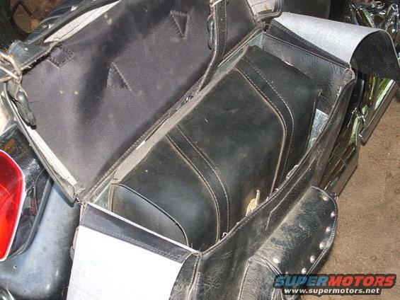 Open motorcycle saddlebag showing contents and interior lining