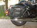 1998 Honda Shadow VT750C - A motorcycle's rear section with black leather saddlebags and chrome exhaust pipes is visible.