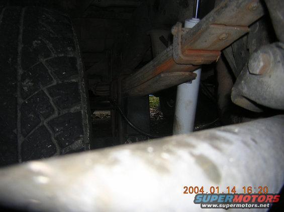 Leaf spring and shock absorber on a vehicle