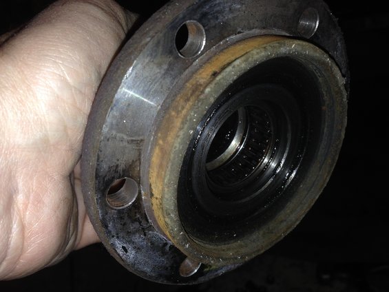 Close-up of a rusty wheel hub assembly with a bearing visible inside