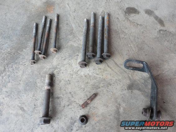 Hardware (clockwise from bottom center):

Water pump mounting stud/nut
Tensioner bolt
A/C compressor bolts
Bracket to engine block mounting bolts
Bracket from back of pump to exhaust manifold bolt (bolt broken in this pic)