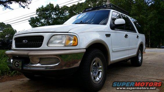 White 1998 Ford Expedition parked on a driveway with a roof rack