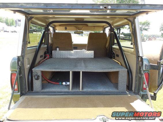 tg8.jpg The t/g carpet is easy to R&I when Frank is carrying hunting dogs (about 3 days a week).  He allows them to climb down from their kennels on the platform, onto the t/g, and jump to the ground.  Then they jump back onto the t/g & climb up to their kennels.  After about 3 years, they haven't done any damage to the Rhino.  I wish I had pulled the carpet for at least one pic, but you'd just see a nice layer of color-matched metal-flake bedliner.

The diamond-plate water tank, & pump are coming out, but the platform can stay with the truck, or be trashed.