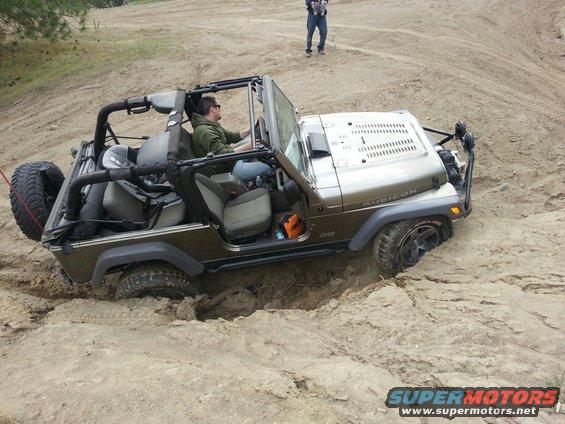 Brown 2005 Jeep Wrangler stuck in sand, Rubicon model