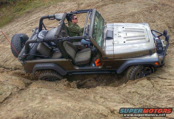 2005 Jeep Wrangler Rubicon stuck in a dirt pit with driver inside