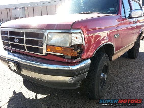 Red 1994 Ford Bronco, front quarter view, damaged headlight