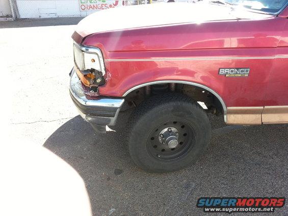 1994 Ford Bronco front fender and headlight damaged, red paint with tan lower trim