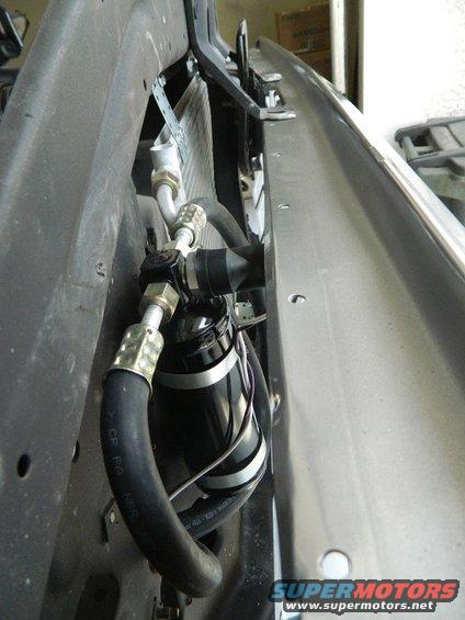 Air conditioning accumulator with hoses and mounting bracket