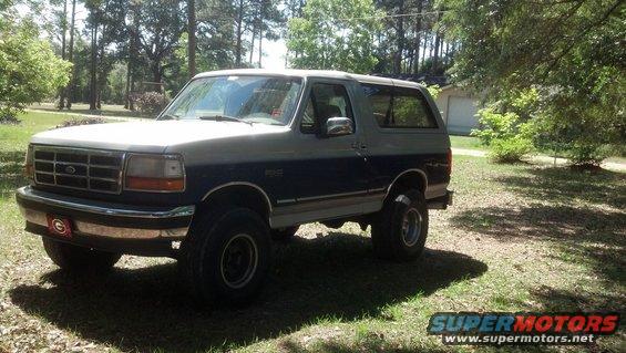Two-tone gray and blue 1996 Ford Bronco parked on grassy area