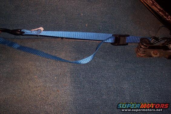 blue strap attached to tailgate torsion bar mechanism