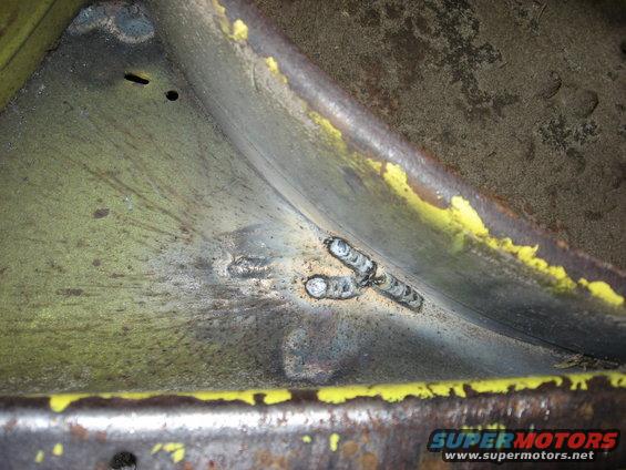 Welding on a yellow and green metal part