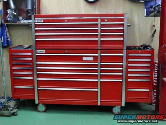 Stack of red tool chests with silver drawer pulls, one chest on the left has a blue item on top
