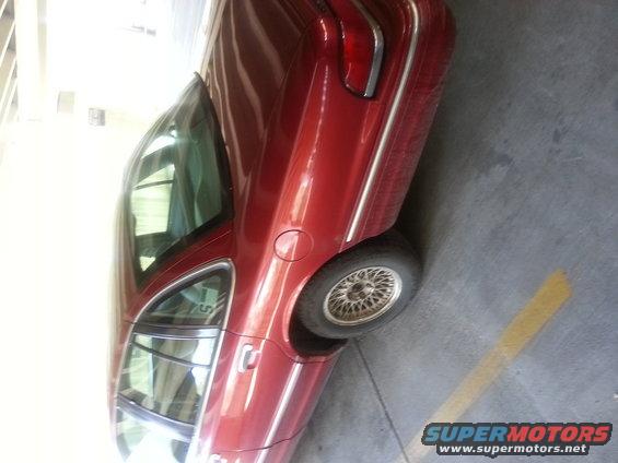 Red 1997 Ford Crown Victoria sedan, side view