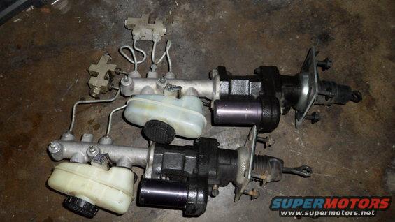 Two brake master cylinders with reservoirs and brake lines
