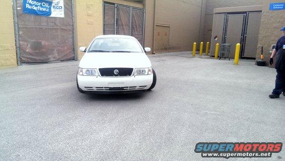 White 2000 Mercury Grand Marquis sedan, front view, parked on asphalt