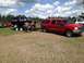 1978 Ford Bronco - A black 1978 Ford Bronco is transported on a trailer, towed by a red Ford F-250 pickup truck.