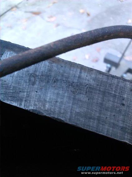 Close-up of a metal part with stamped numbers 094351