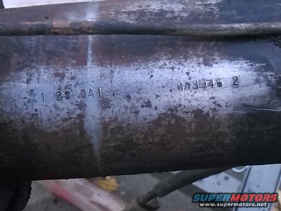 Close-up of a metal part with stamped numbers: 1 28 OA1 and 6A3946 2