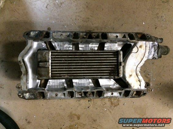 supercharger assembly with intercooler, looks like it's for a V8 engine