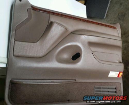 1994 Ford Bronco driver's side door panel with wood trim and speaker grille