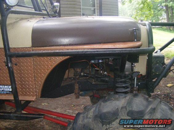 Custom buggy with diamond plate fender, exposed engine, and large tires