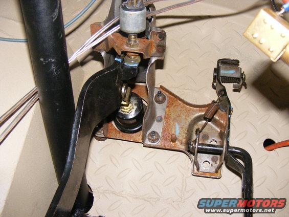 Clutch pedal assembly with rusty metal bracket and black pedal arm