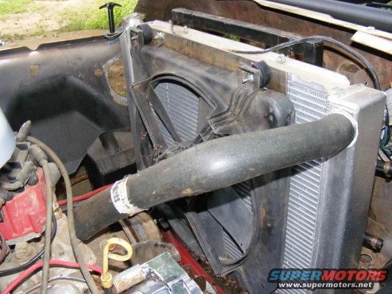 Radiator and fan assembly with hose and dipstick
