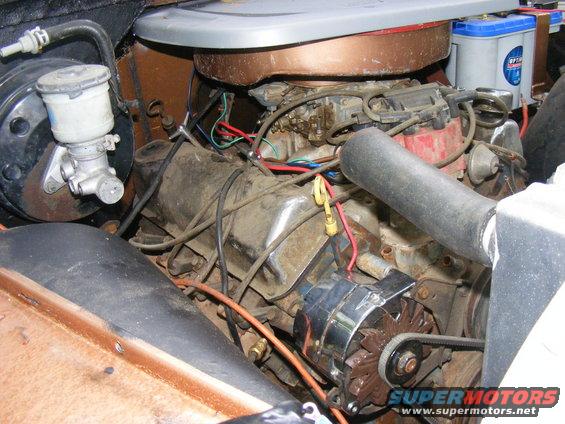 Engine bay showing alternator, brake master cylinder, carburetor, and battery. Supermotors.net logo visible