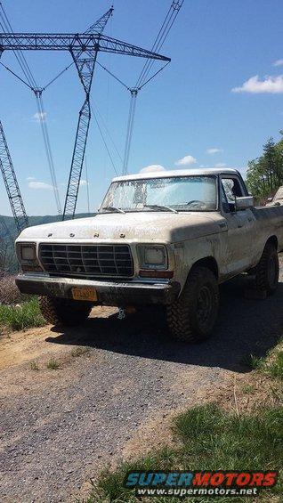 1979 Ford F-150 truck, 3q-front view, dirty white exterior, on gravel road