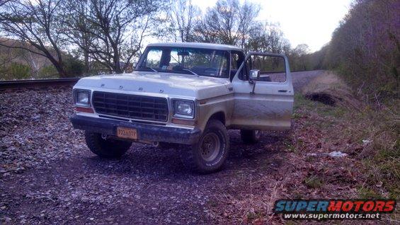 1979 Ford F-150 with driver door open, parked on gravel near railroad tracks