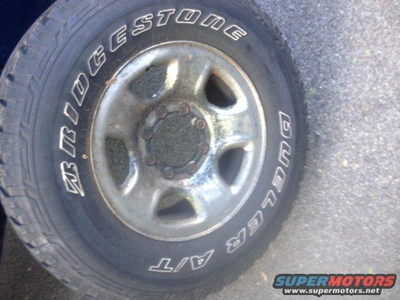 Close-up of a Bridgestone Dueler A/T tire on a silver wheel