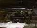 1988 Ford Bronco - The engine bay of a vehicle, an aftermarket intake system with a red air filter.