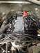 1988 Ford Bronco - Close-up view of an engine bay, showing a red fuel pressure regulator and numerous spark plug wires.