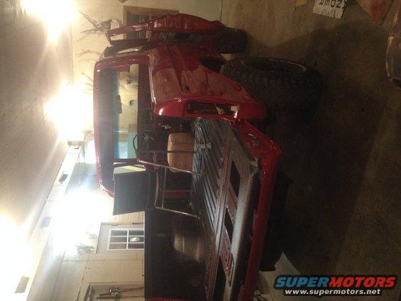 1978 Ford Bronco rear view, red paint, in garage