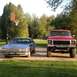 1978 Ford Bronco - A red 1978 Ford pickup truck and a blue sedan are parked outside on a sunny day.