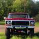 1978 Ford Bronco - Front view of a lifted red Ford truck with a prominent grille and chrome accents.