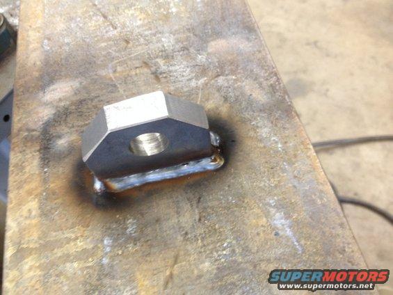 Welded metal part with hexagonal nut and threaded hole