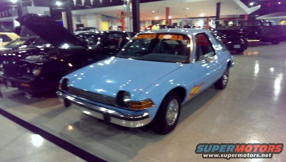 Blue AMC Pacer with flame decals and 'BUSINESS WORLD' on windshield