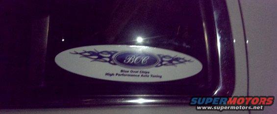 Close-up of a sticker on a car door that says "BCC Blue Oval Chips High Performance Auto Tuning"